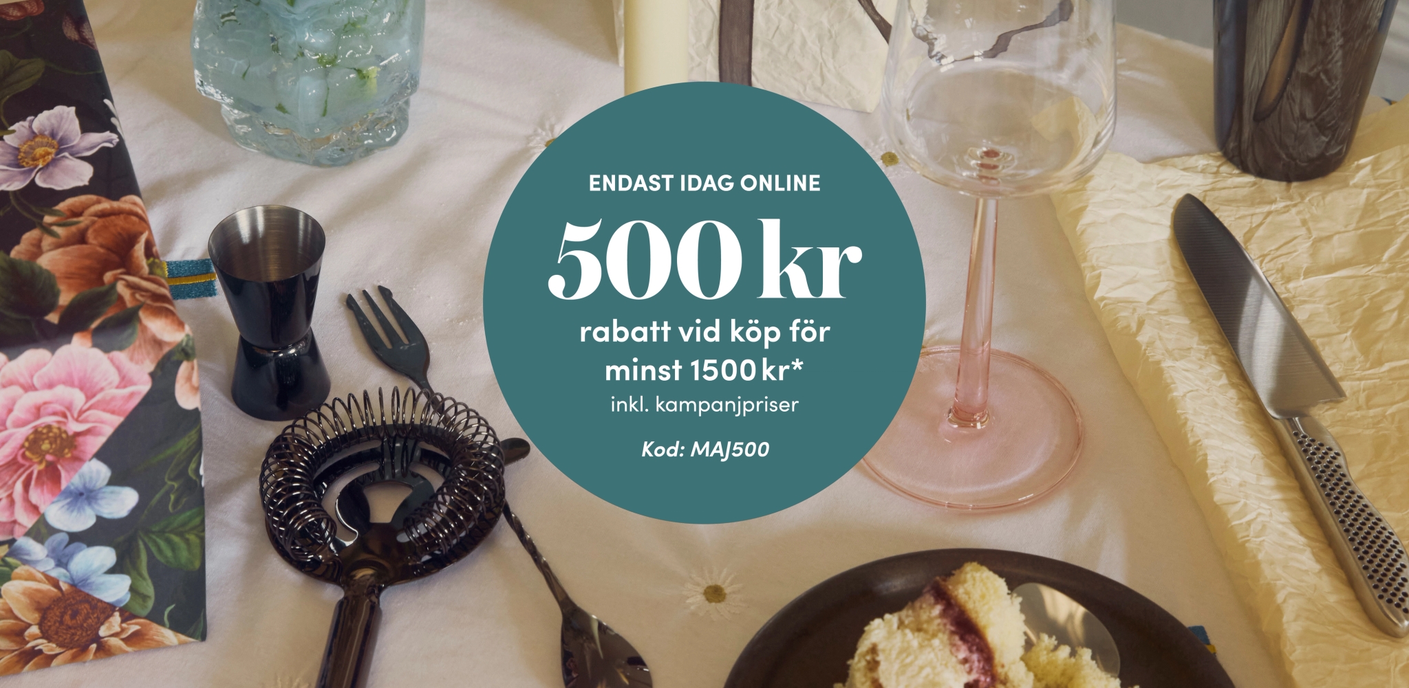 Kampanjbild med dukat bord och text som erbjuder 500 kr rabatt vid köp över 1500 kr online med rabattkod MAJ500.