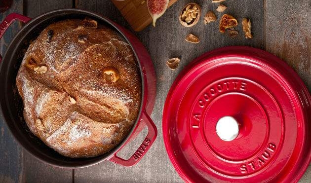 Tuore leipä punaisessa Staub-valurautapadassa juuston, saksanpähkinöiden, viikunoiden ja punaviinin kanssa