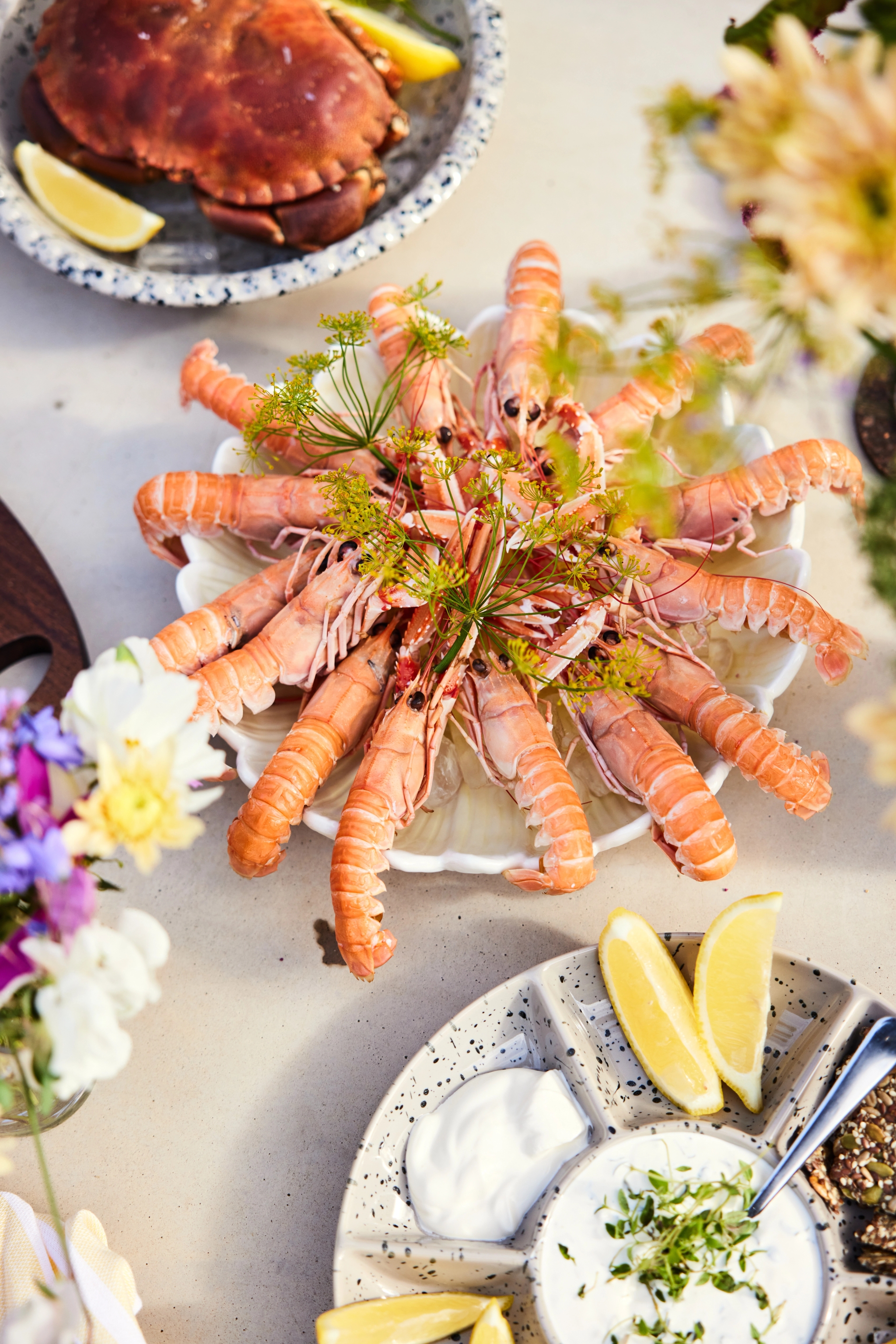 Äyriäisbuffet katkaravut tarjoiluastialla lisukkeiden kera