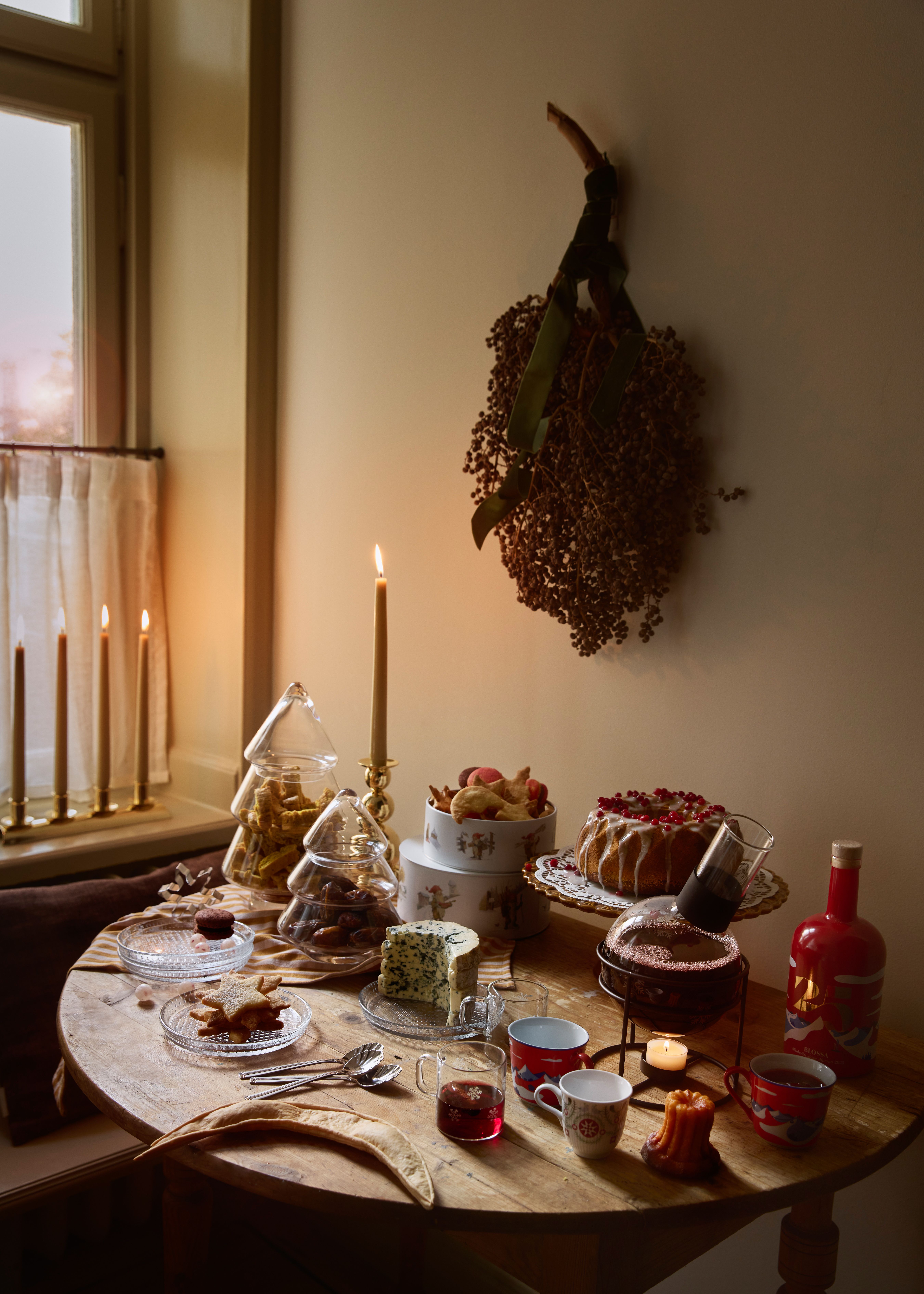 a table with a variety of desserts and candles on it