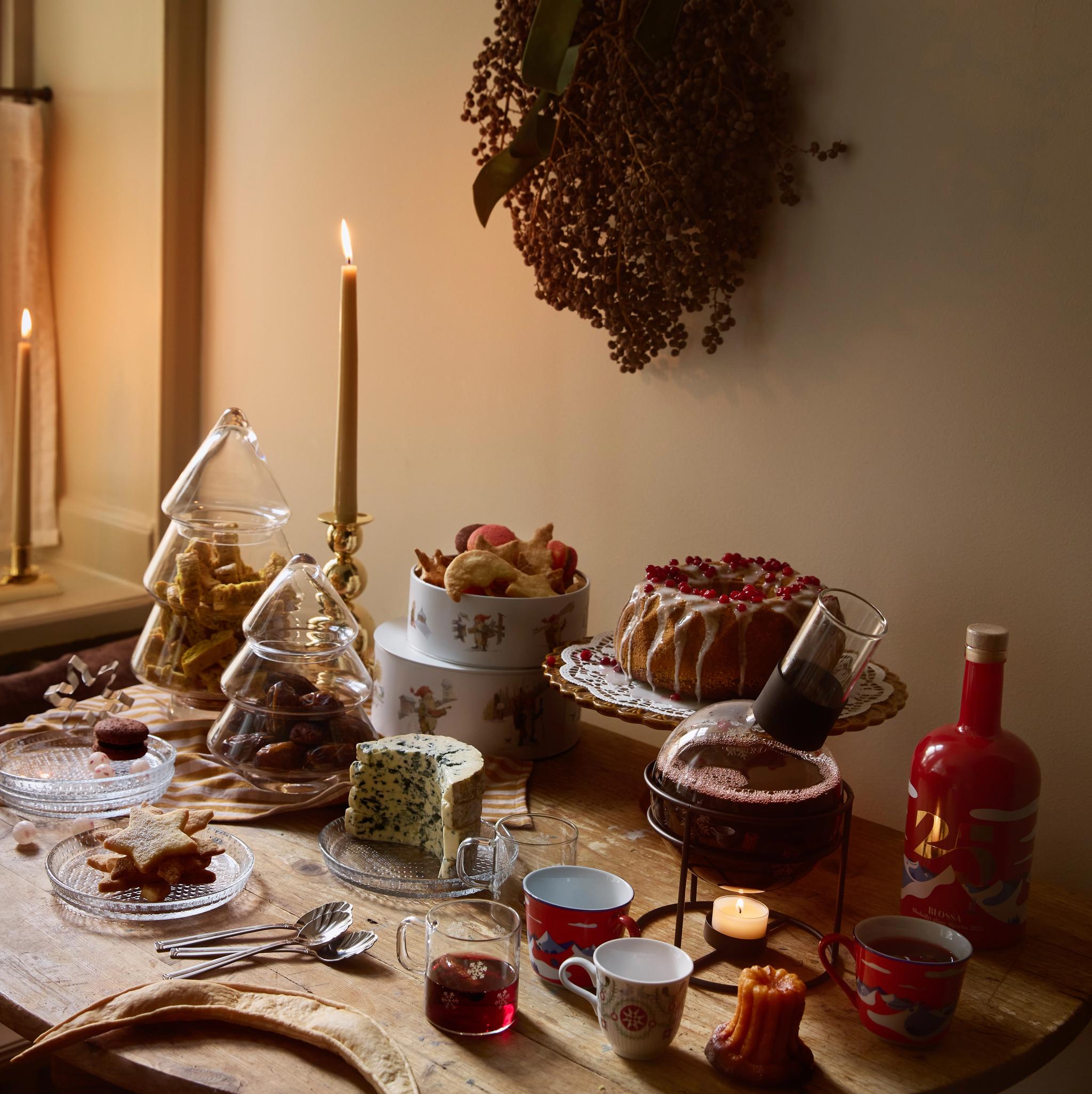 a table with a variety of desserts and candles on it