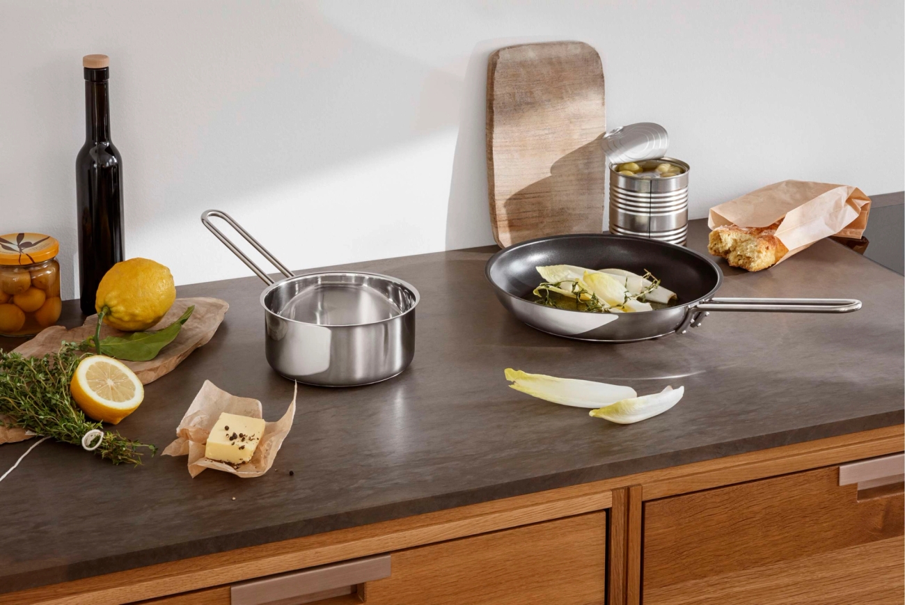 Matlagning, stekpannor, grönsaker, rotfrukter utspridda på ett bord
