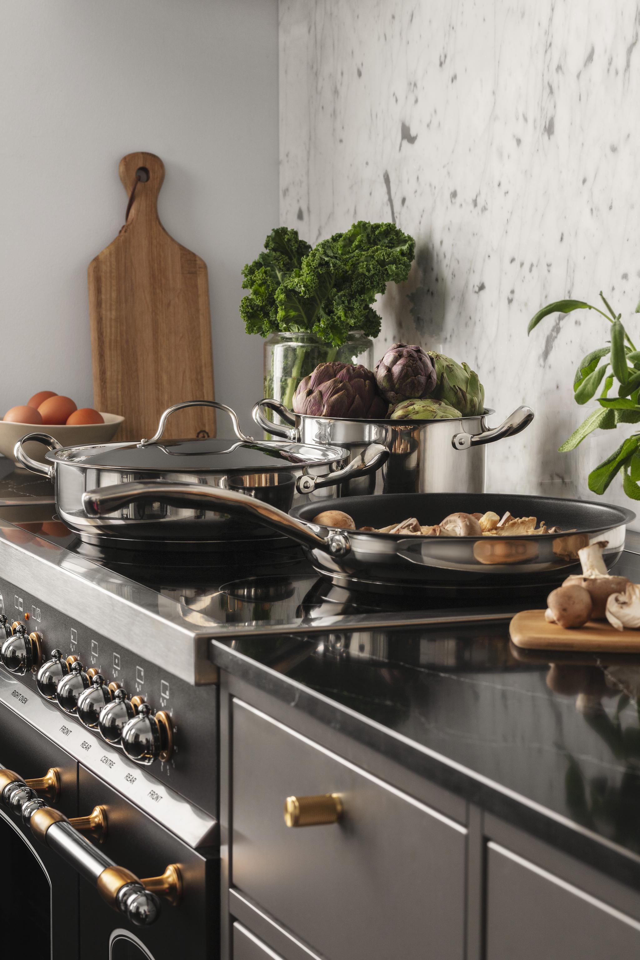 pots and pans are cooking on a stove in a kitchen