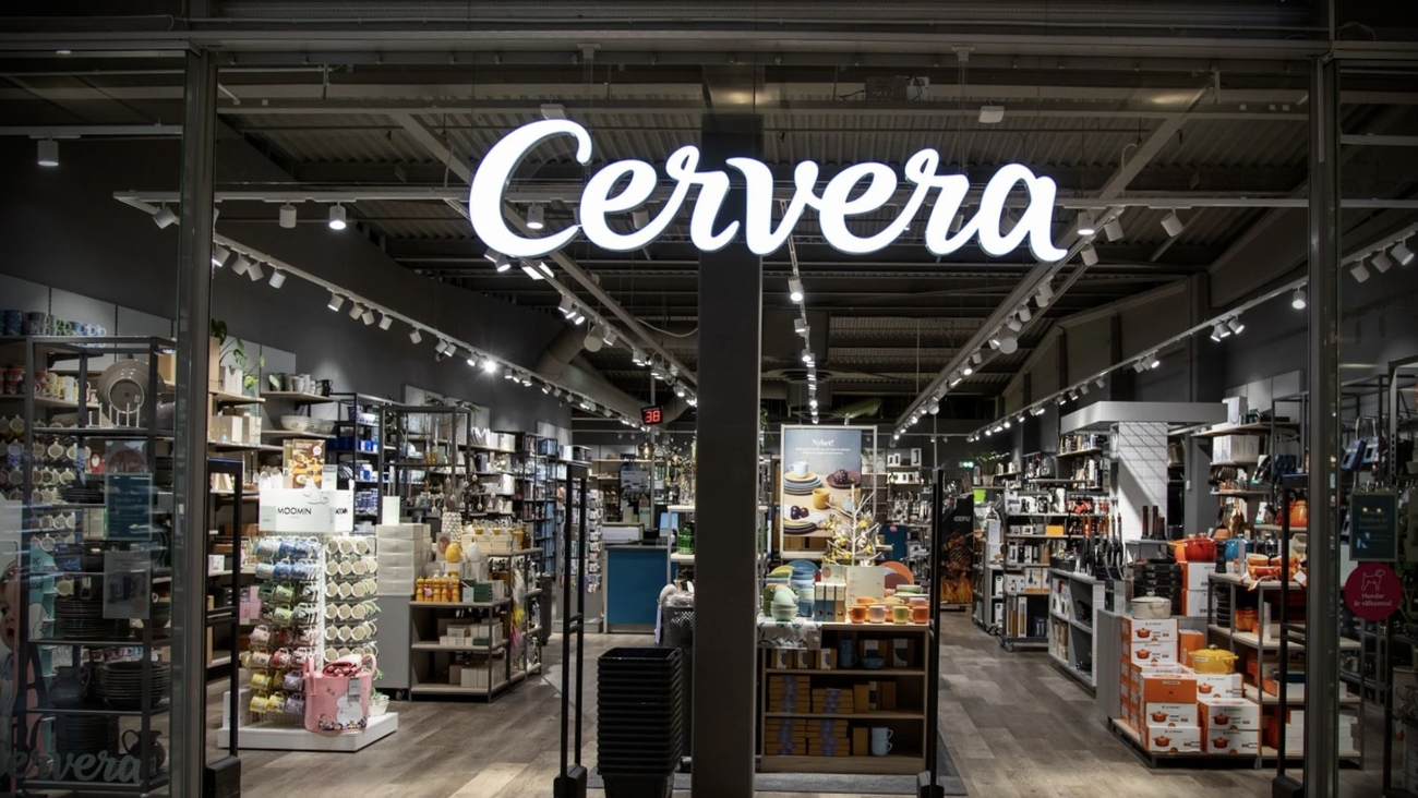 Cervera store entrance with an illuminated sign and shelves of housewares inside.