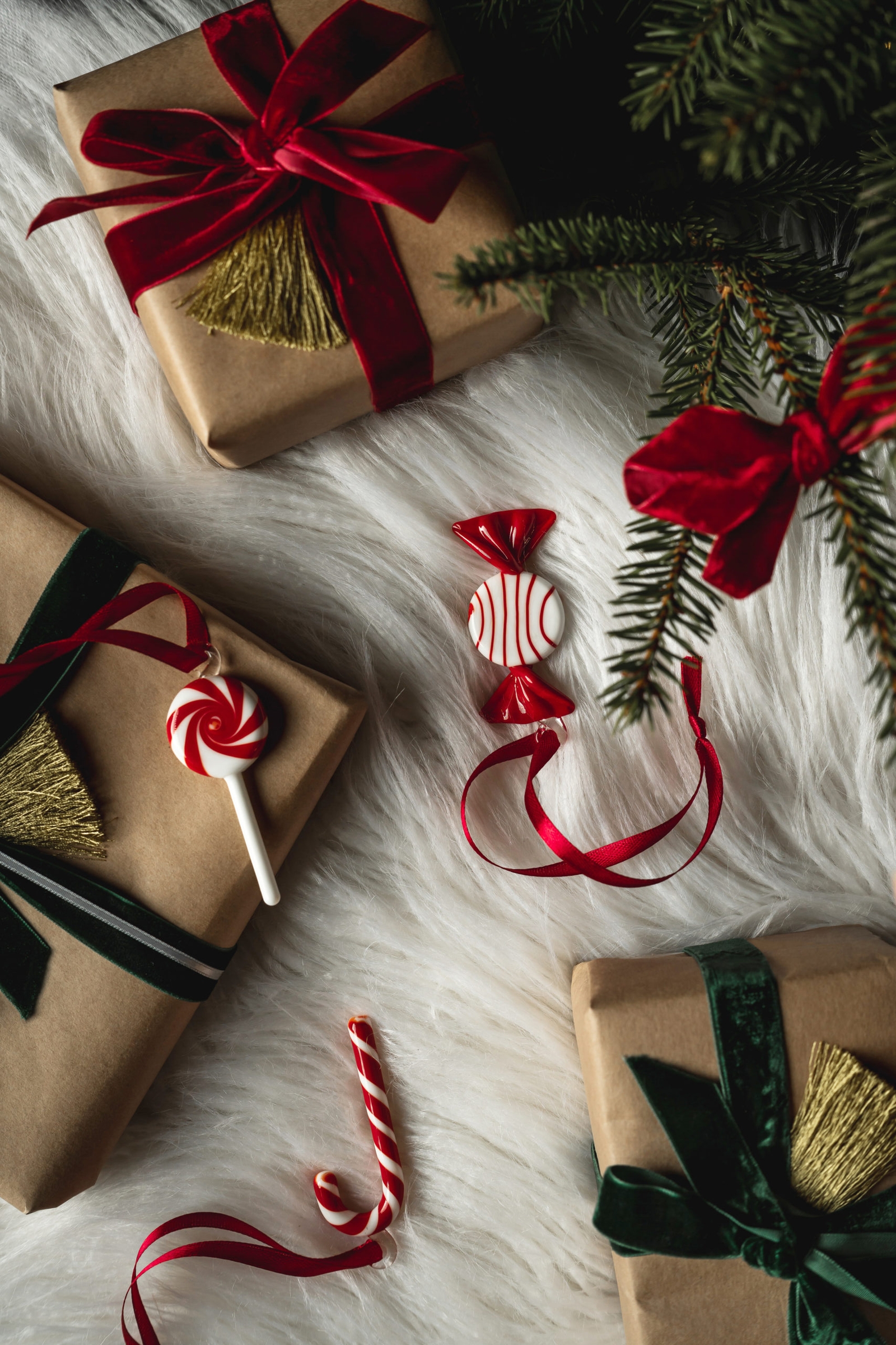 christmas presents wrapped in brown paper with red and green ribbons