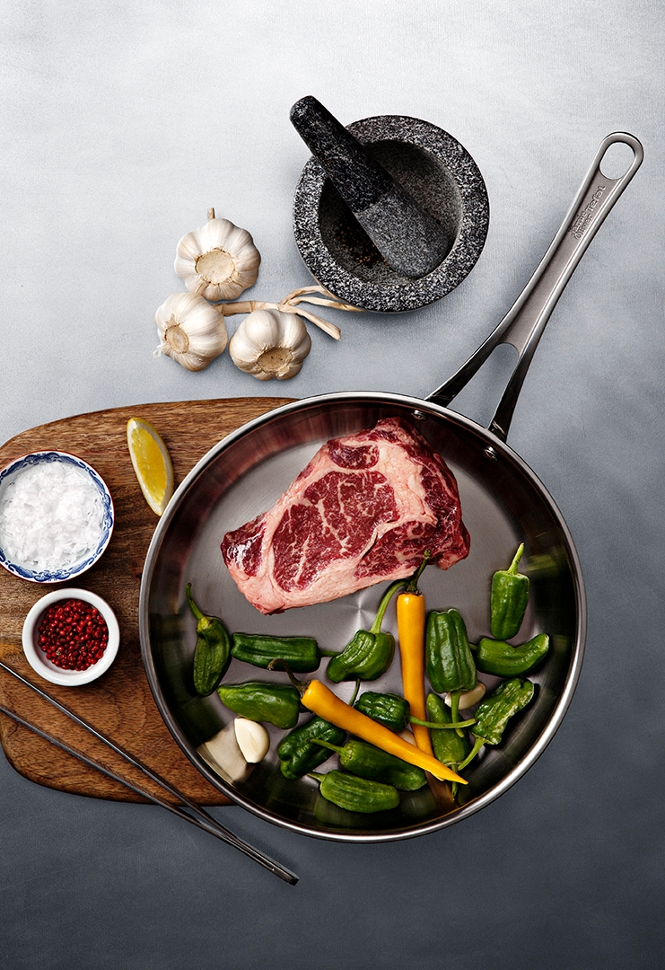 rostfri stekpanna med köttbit