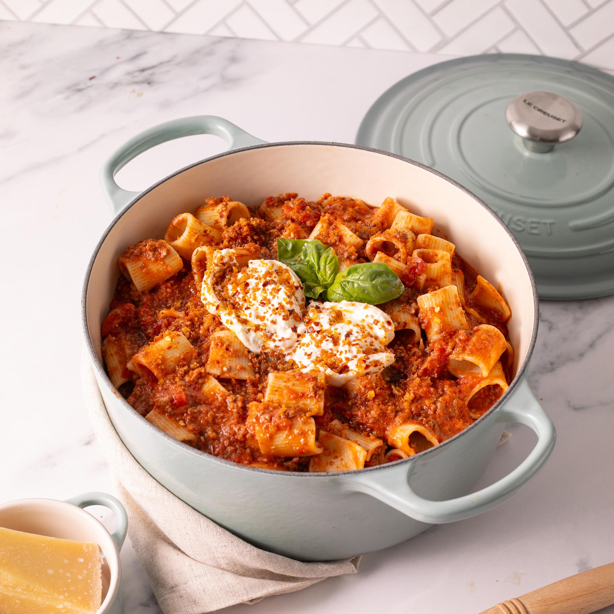 Le Creuset støpejernsgryte i fargen Sea Salt med pasta og tomatsaus i