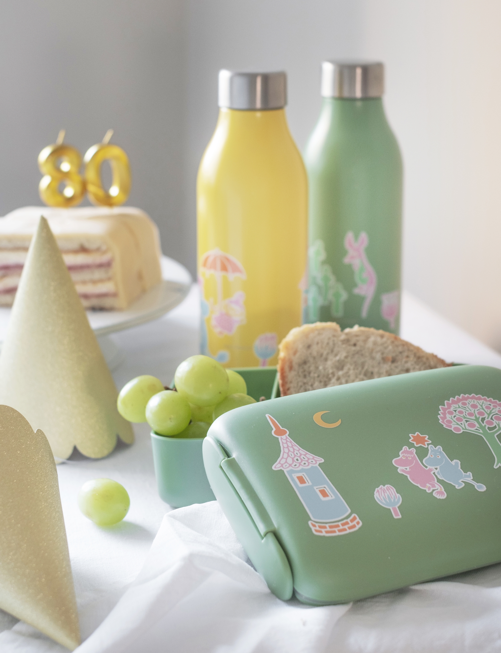 Muumi Juhlat kokoelman eväsrasia ja termospullot väreissä vihreä ja keltainen