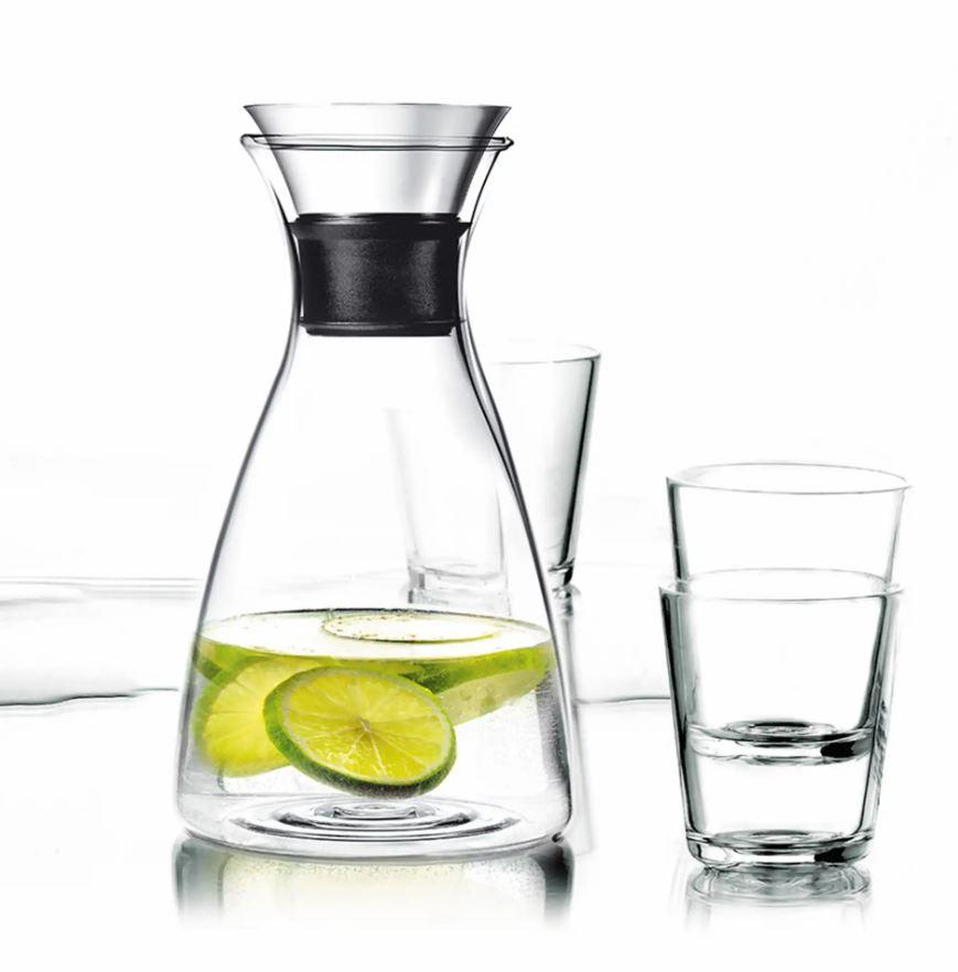 a pitcher of water with lime slices in it