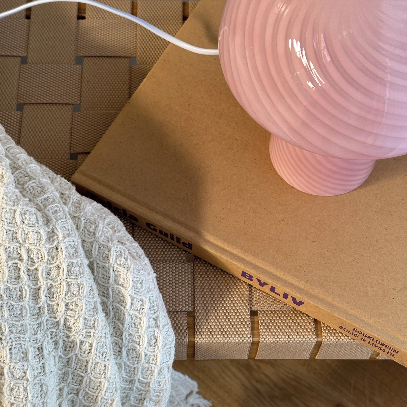 Vaaleanpunainen sienilamppu kirjan päällä