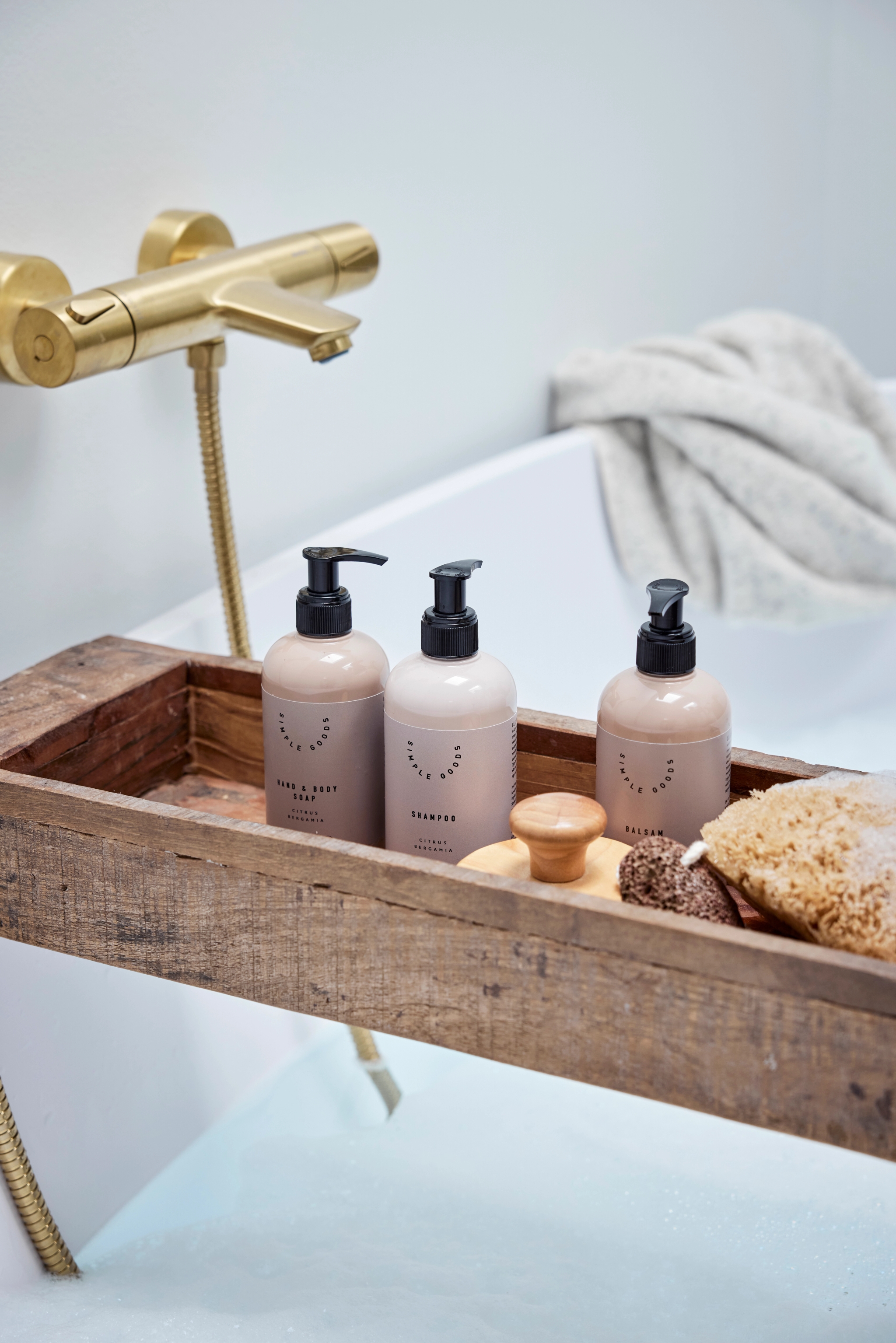 En bricka över ett badkar med tvålar och schampo