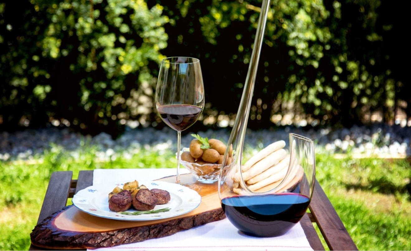 Riedel karaffel med rødvin i på en utendørs piknik