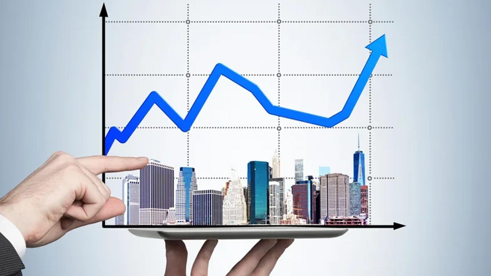 Imagem de edifícios com um gráfico ao fundo.