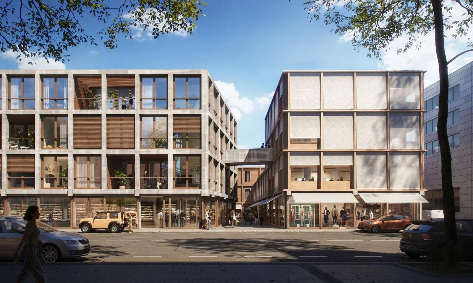 Edifícios de coliving em Madri Fachada de dois edifícios residenciais de cinco andares com varandas, em rua arborizada
