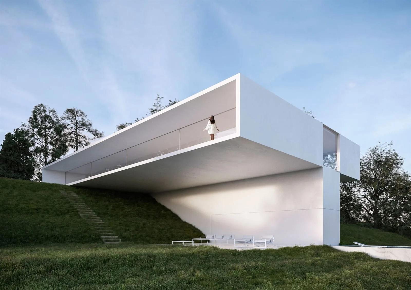 Casa branca com volume superior em grande balanço sobre um gramado em declive, com árvores ao fundo