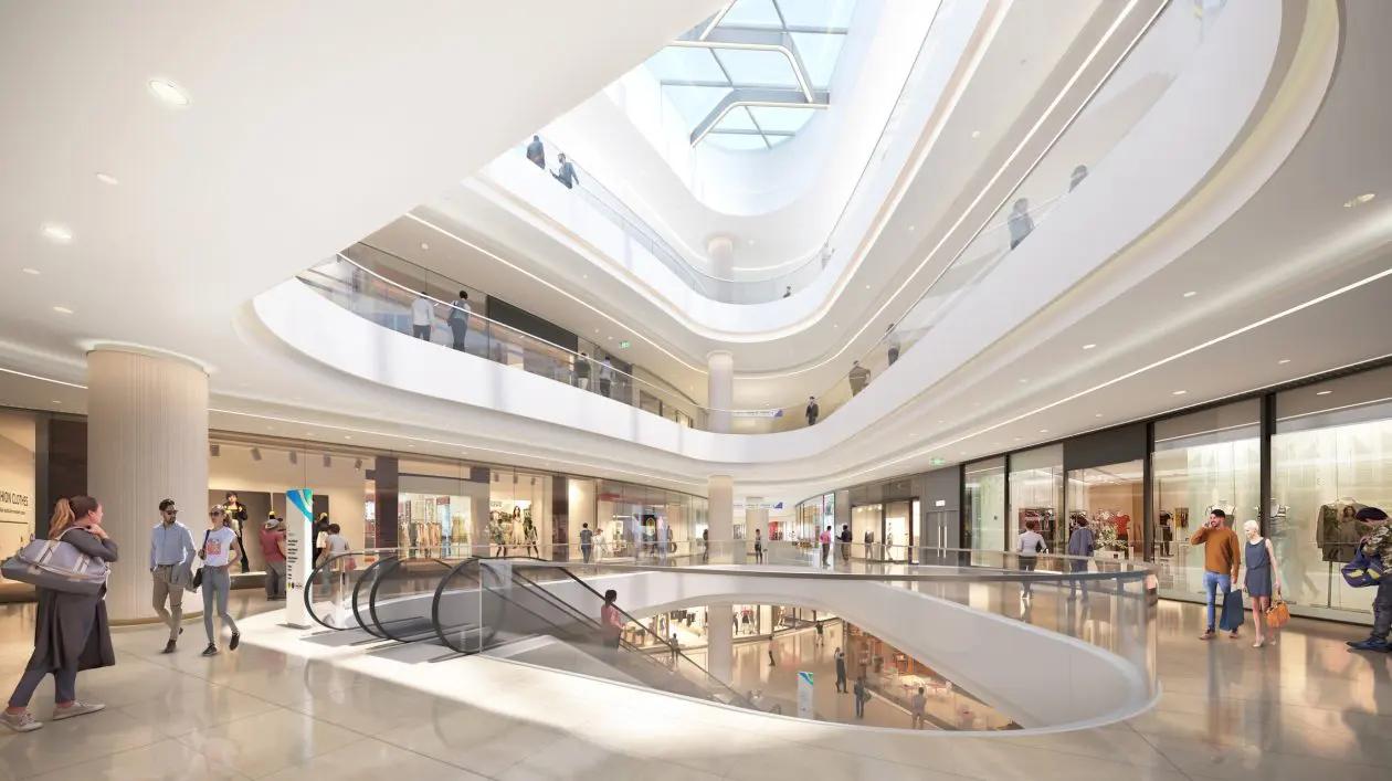 Área comum de shopping center Átrio de shopping center com escadas rolantes, claraboia e lojas em dois pisos
