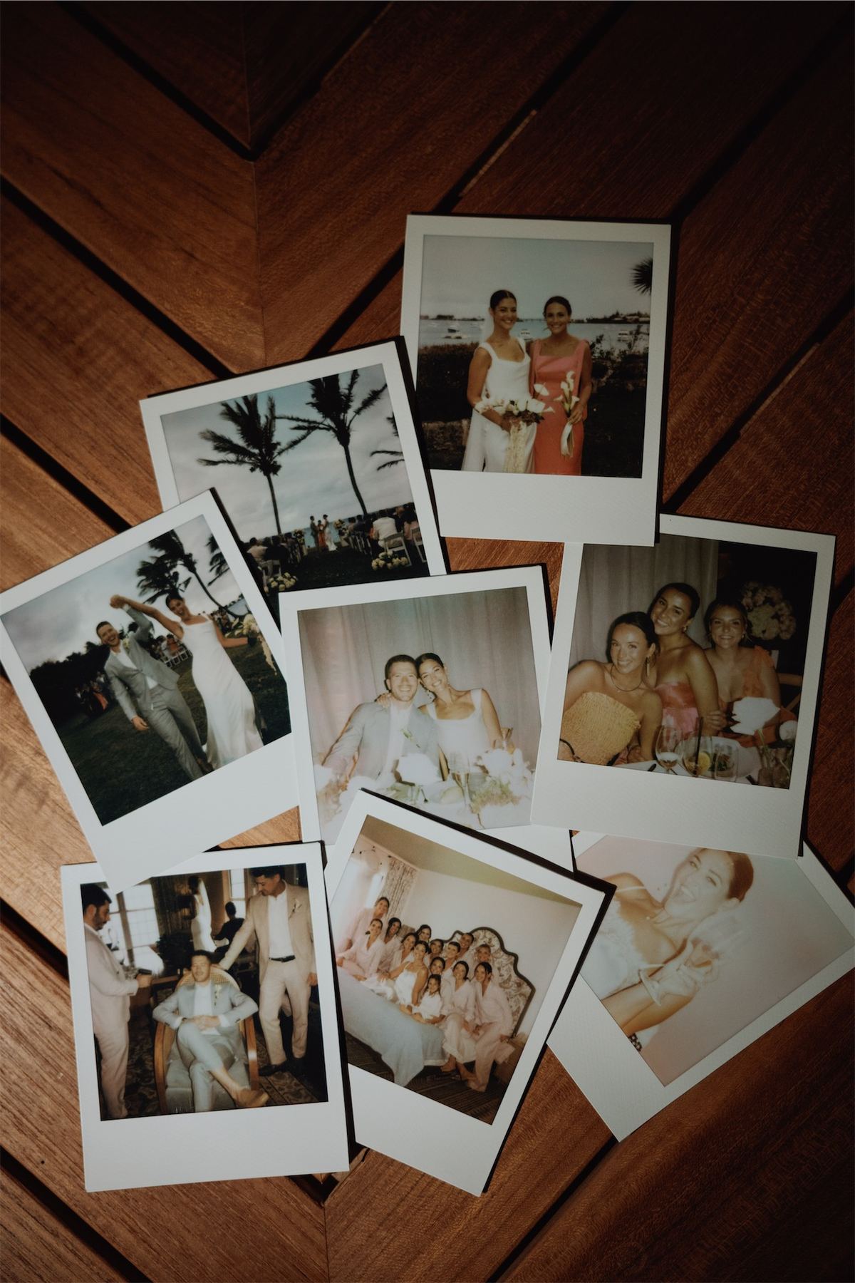 Polaroid prints from the day scattered across a wooden table