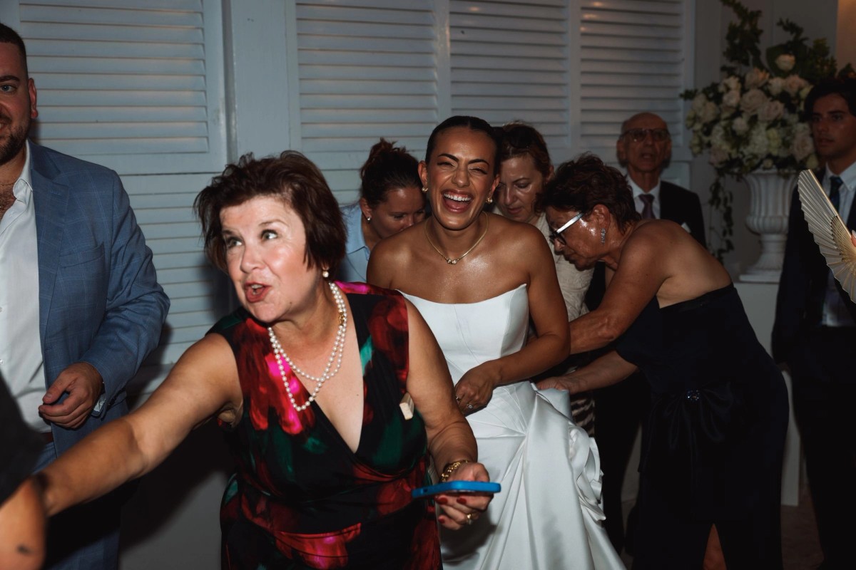 Bride laughing in the middle of a crowd of family at Rosewood Bermuda