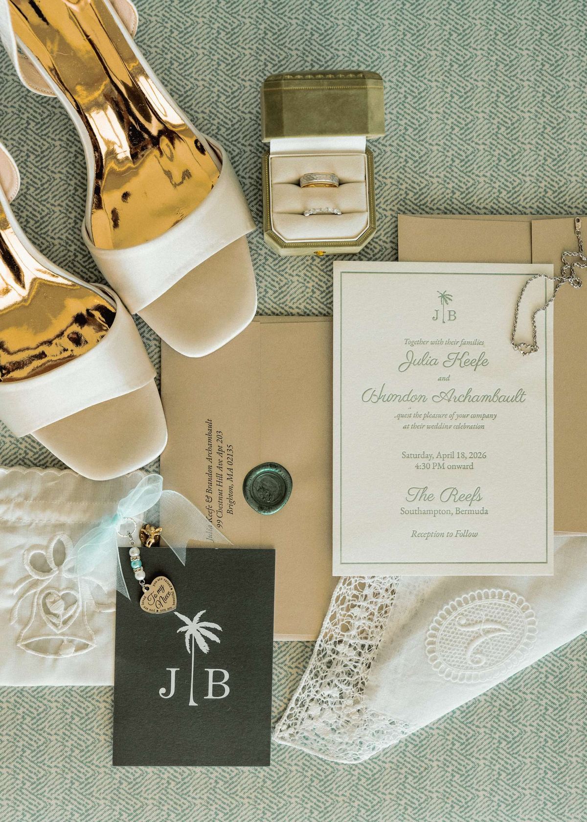 Flat lay detail of wedding invitation suite with champagne and JB monogram