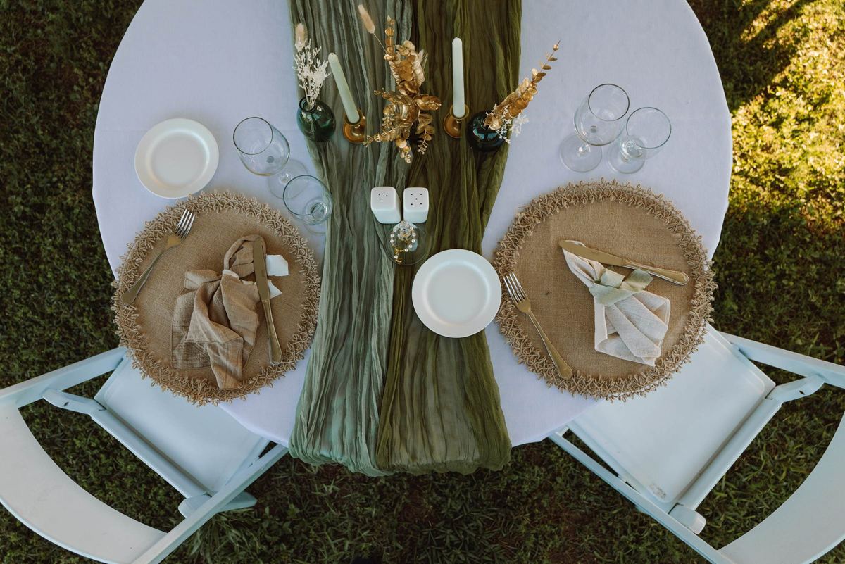 Overhead view of the reception table setting with a green runner