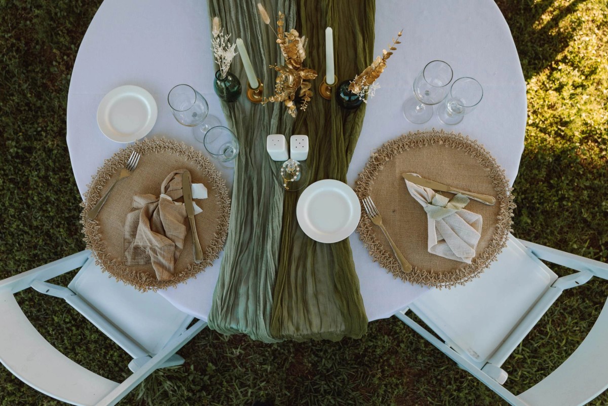 Overhead view of the reception table setting with a green runner