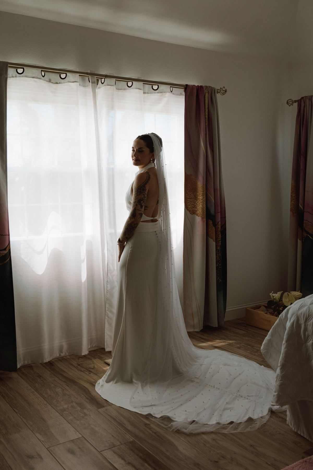 Bride alone in the room with her train spread across the floor