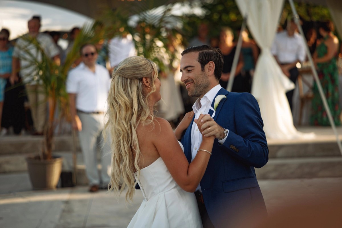 Paige and Cam share their first dance under the tent at golden hour on Hawkins Island, Bermuda