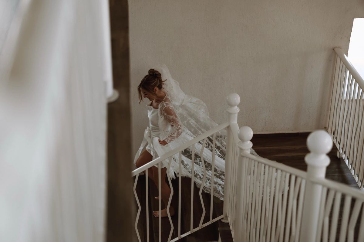 Overhead artistic shot of bride on grand staircase at luxury wedding venue