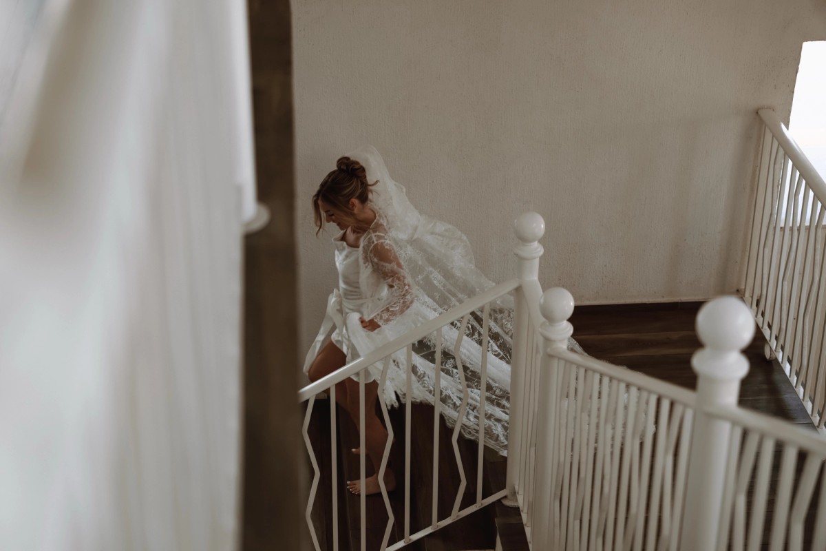 Overhead artistic shot of bride on grand staircase at luxury wedding venue