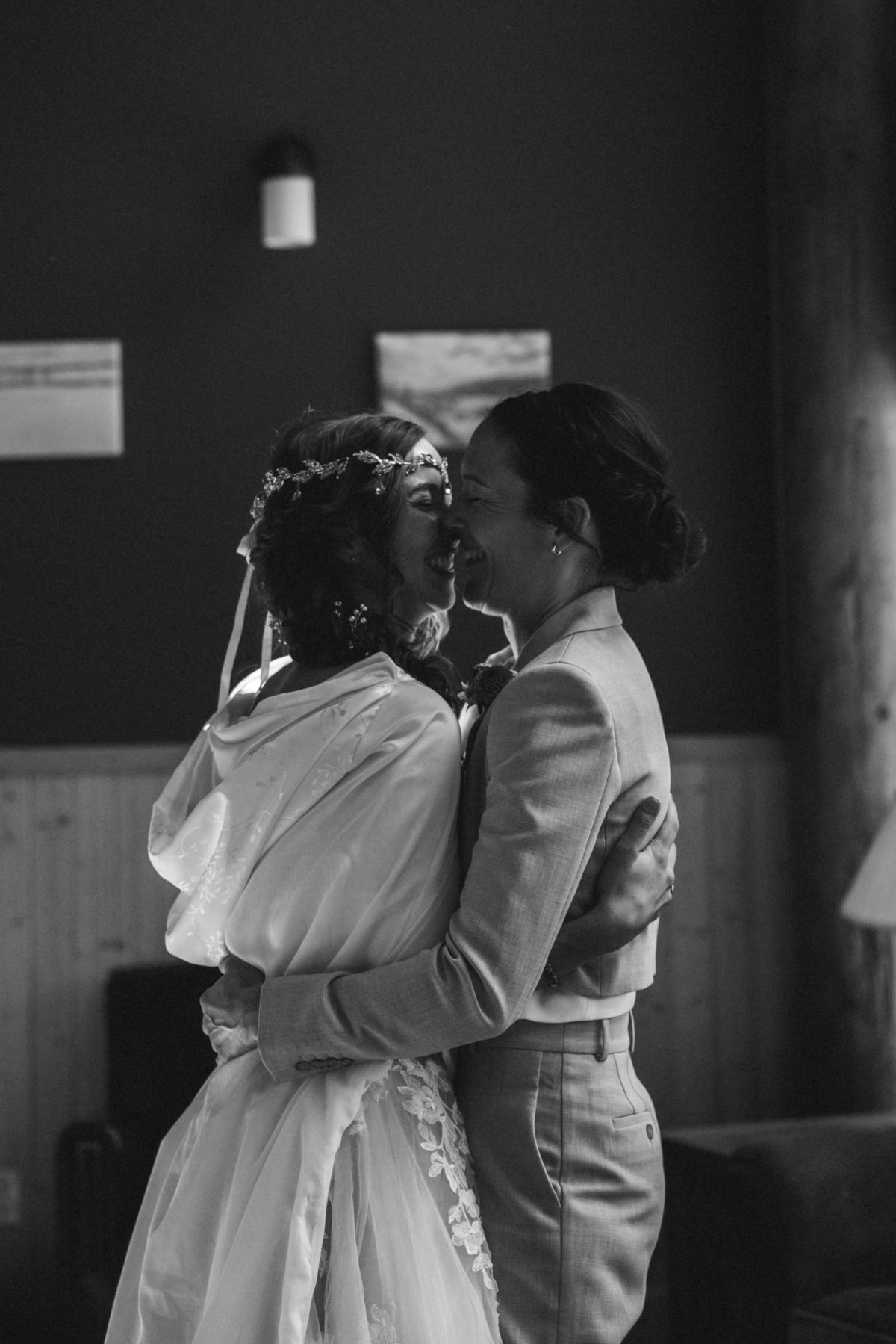 Black and white of the two brides holding each other forehead to forehead