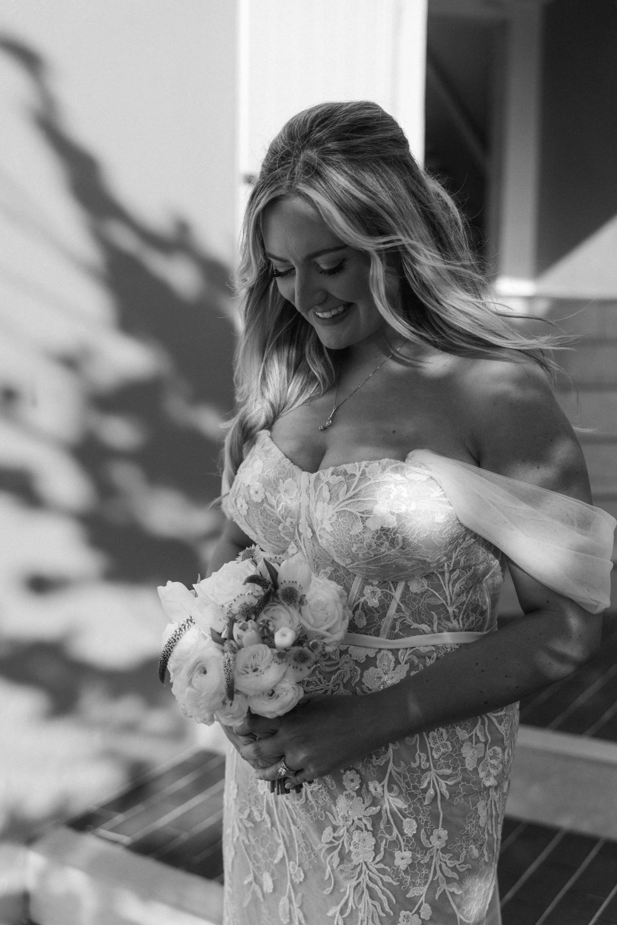 Black and white portrait of bride holding bouquet during getting ready