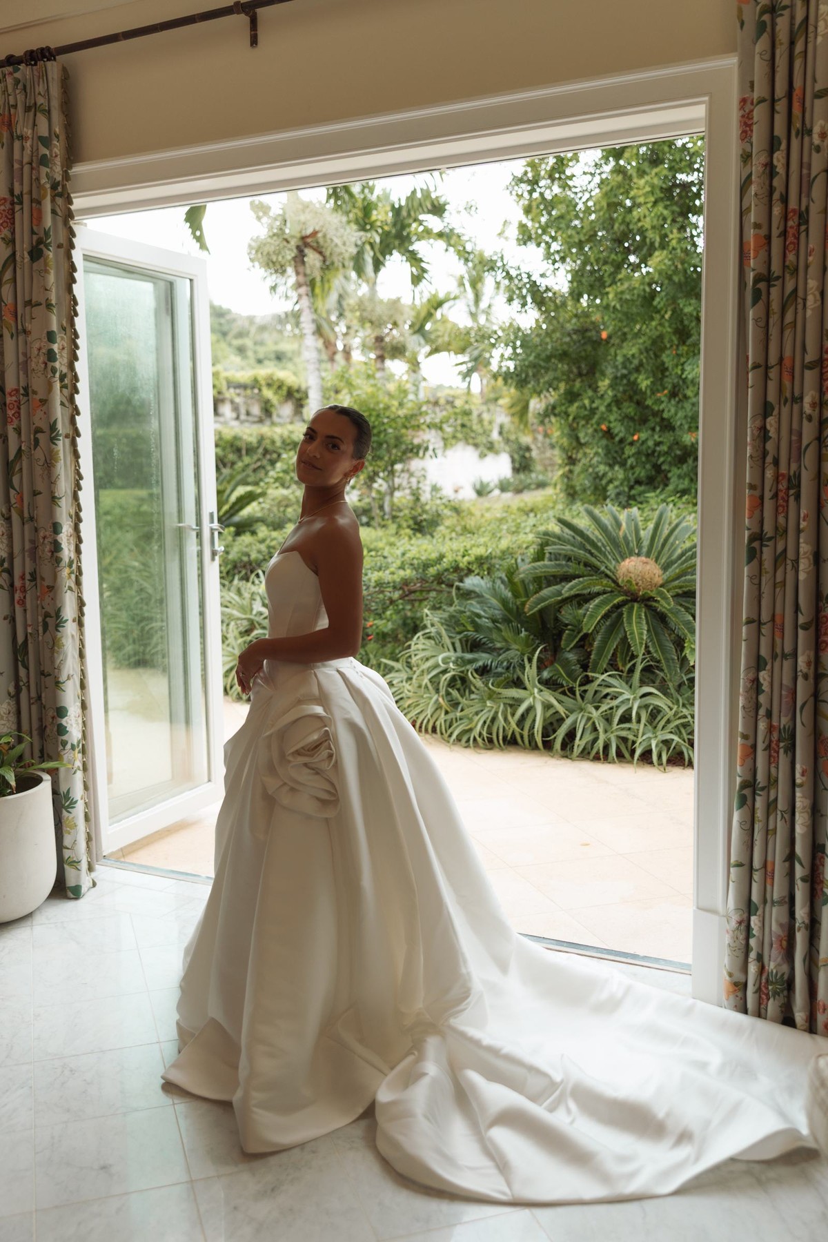 Bride in a strapless ballgown framed by open garden doors at Rosewood Bermuda