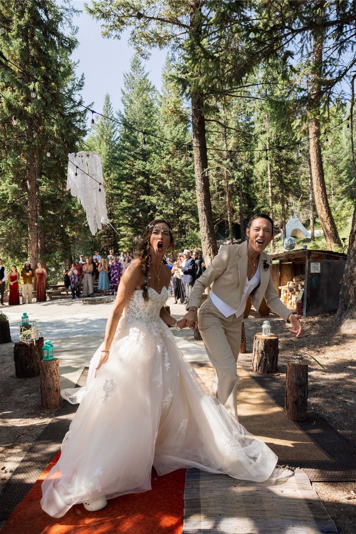 Bride in a full tulle gown walking the aisle along a forest path