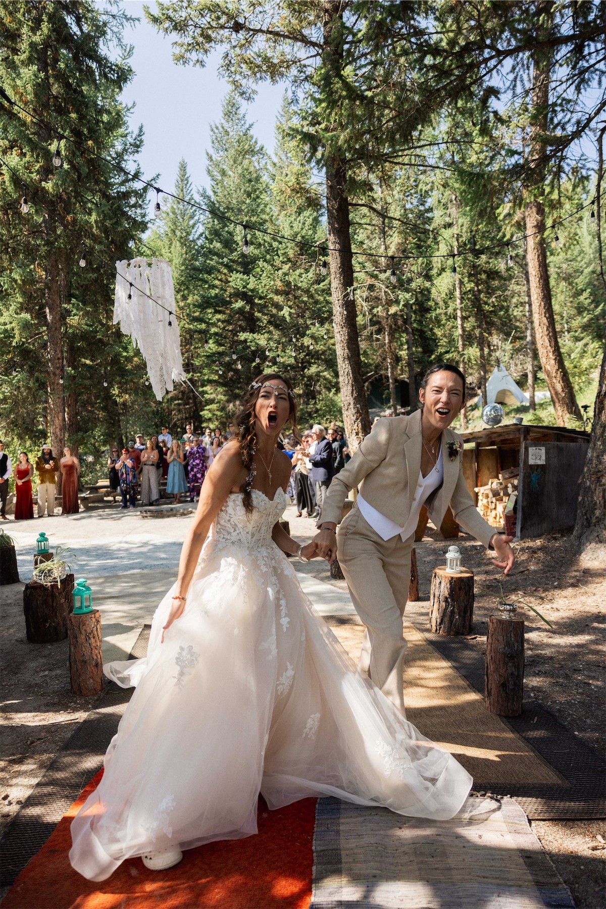 Bride in a full tulle gown walking the aisle along a forest path