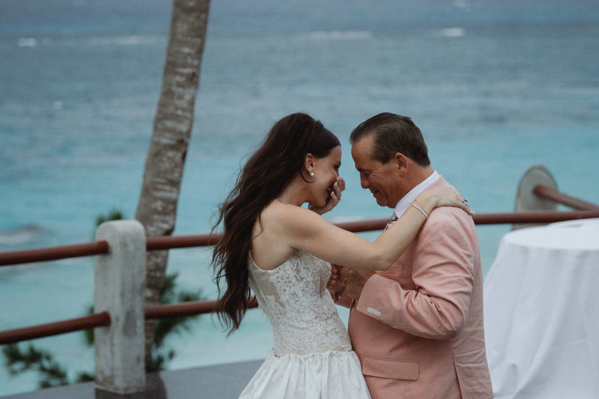 Bride sharing emotional moment with father figure at wedding reception