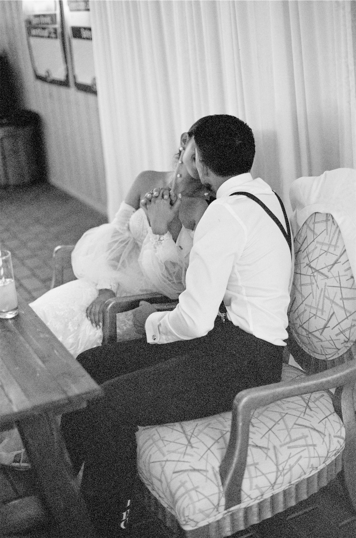 Black and white of the newlyweds sharing a quiet moment together indoors