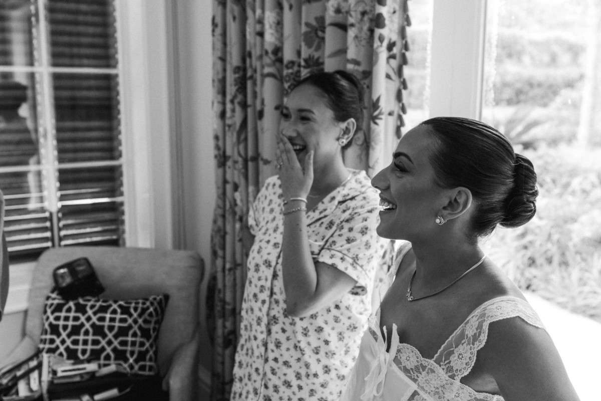 Bride laughing with her mother while getting ready at Rosewood Bermuda, black and white