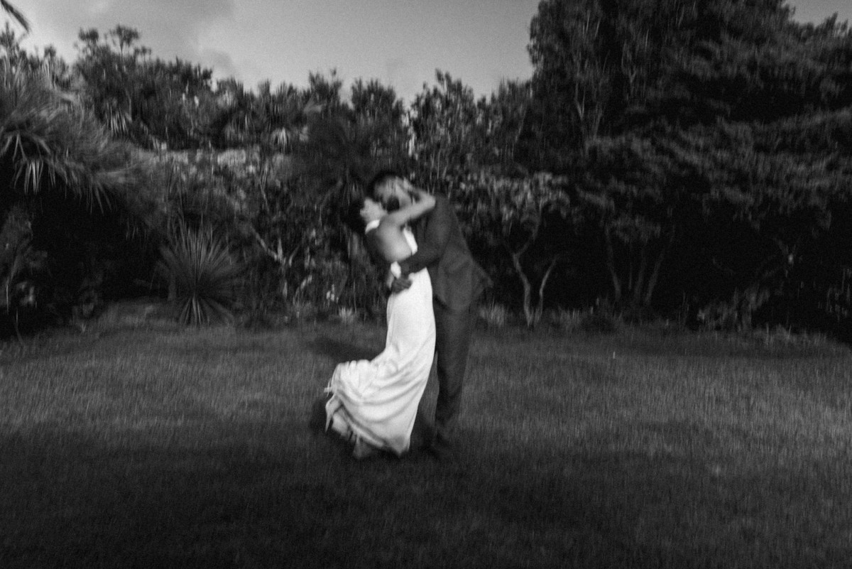 Black and white photograph of the couple holding each other in a Bermuda garden