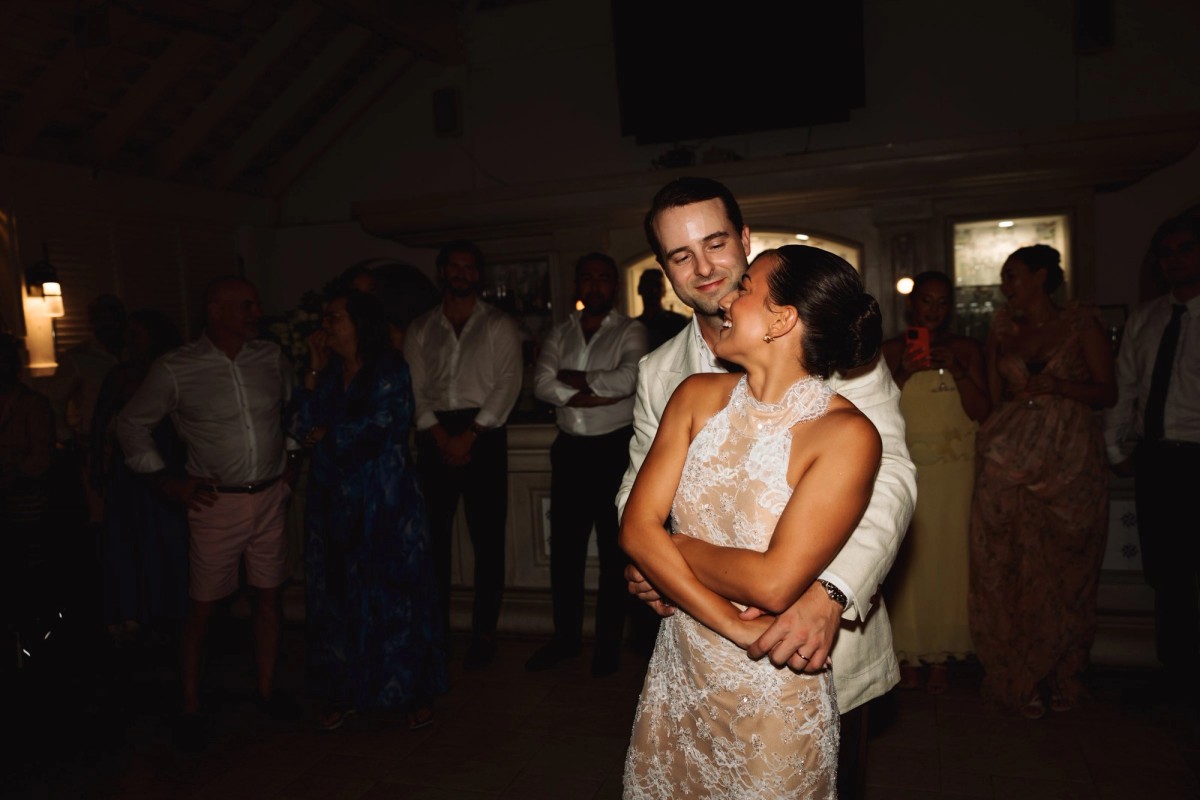 Couple embracing during their first dance surrounded by guests at Rosewood Bermuda