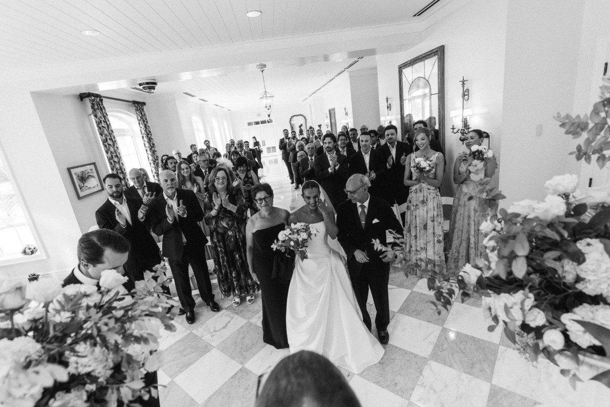 Bride walking down the aisle between her parents at Rosewood Bermuda, black and white
