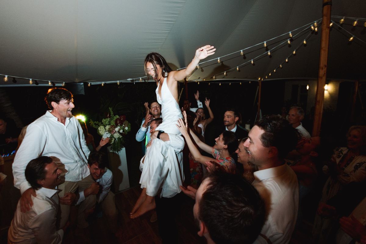 Bride lifted above the crowd on the dance floor at a Bermuda wedding