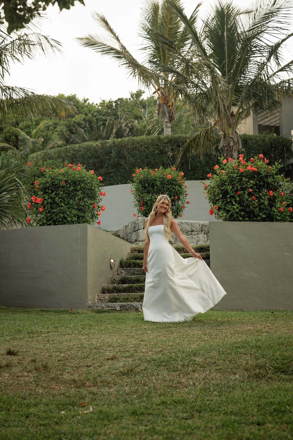 Paige swirls her gown on the garden lawn below the hibiscus on Hawkins Island, Bermuda