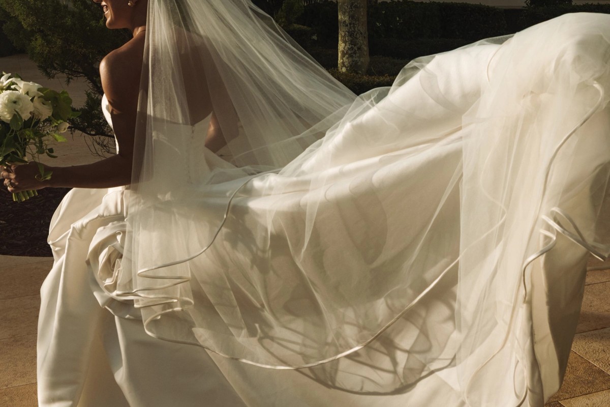 Bride's veil and train lifting in golden evening light at Rosewood Bermuda