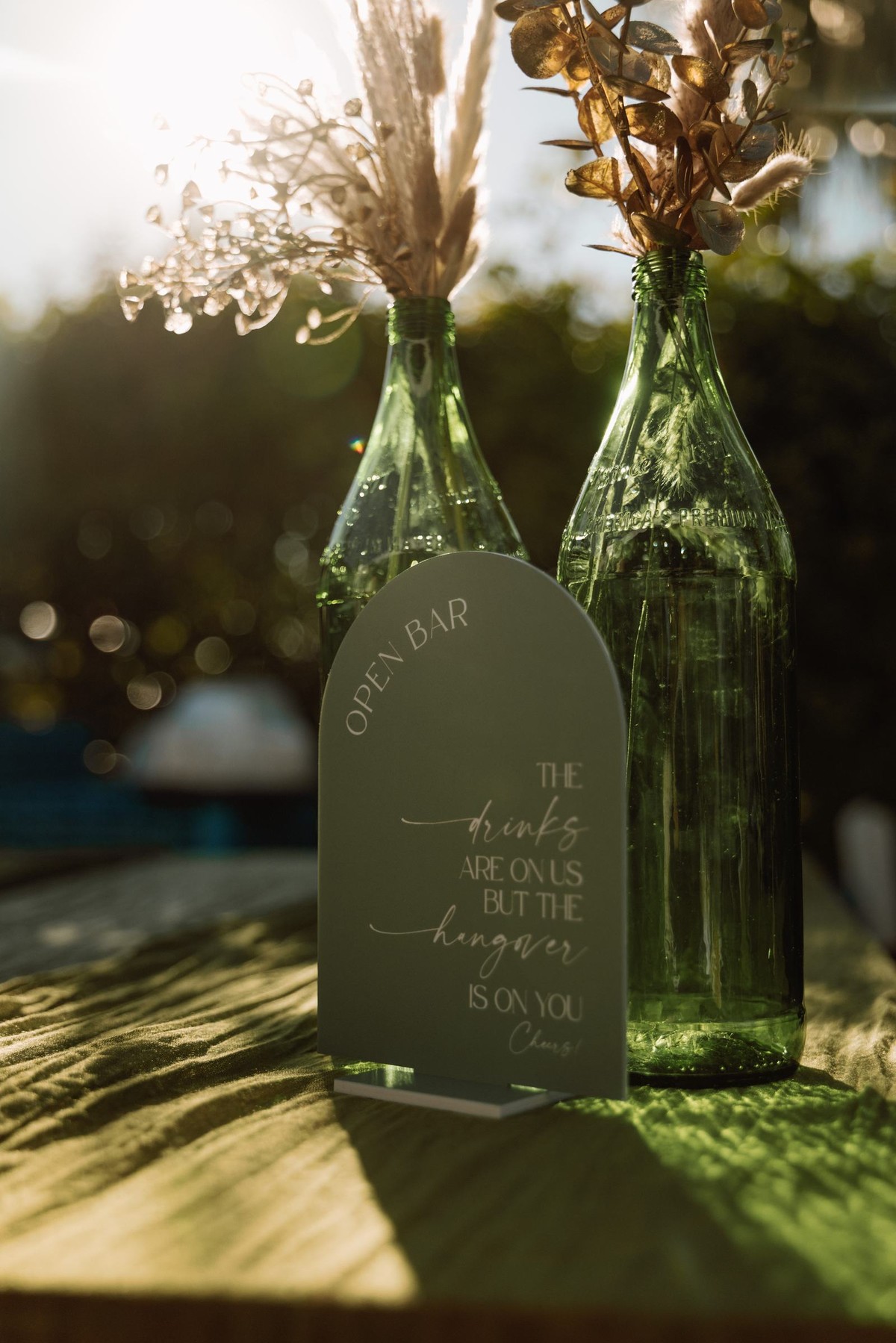 Open bar sign with dried florals in the golden hour light