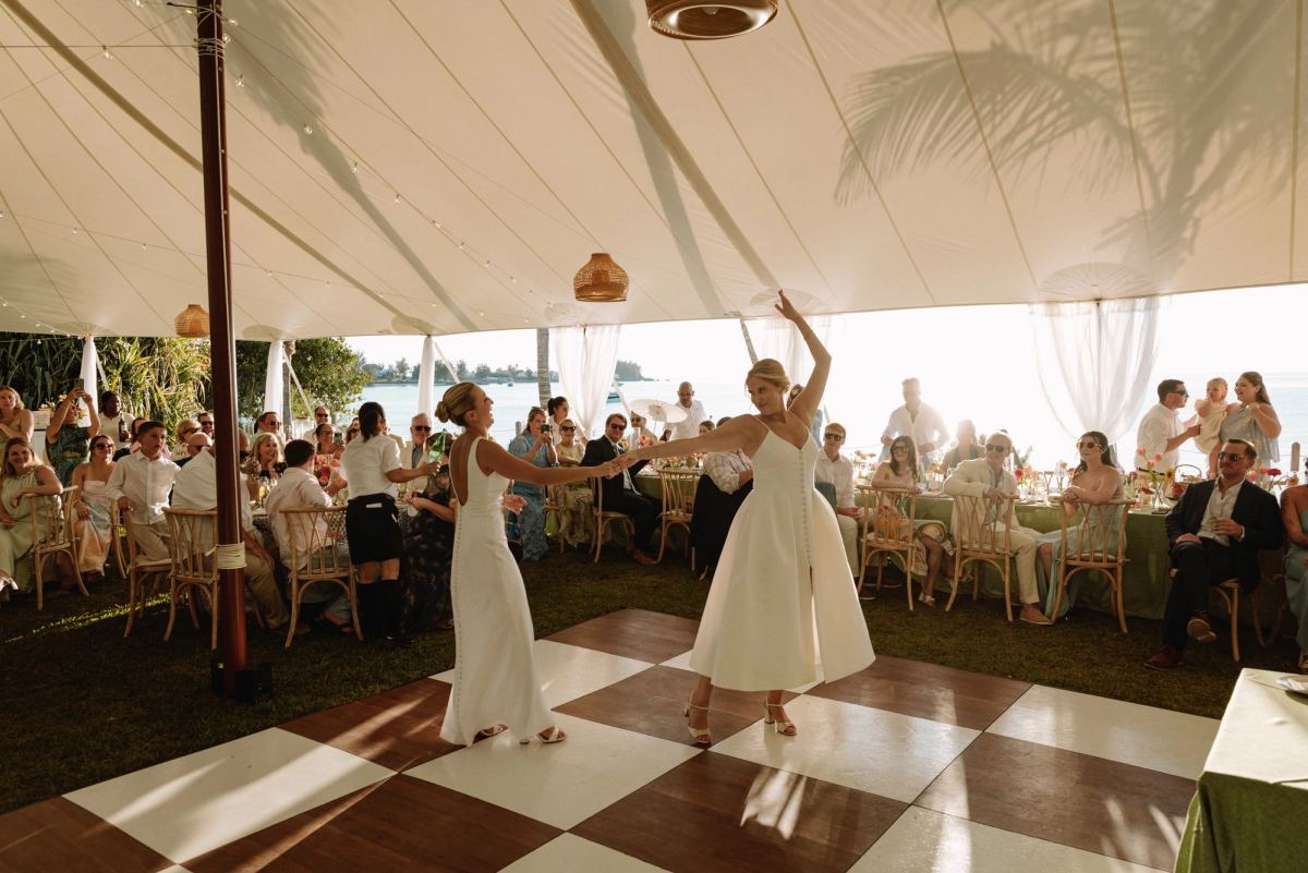 First dance on a checkerboard floor inside a sailcloth tent at a Bermuda wedding