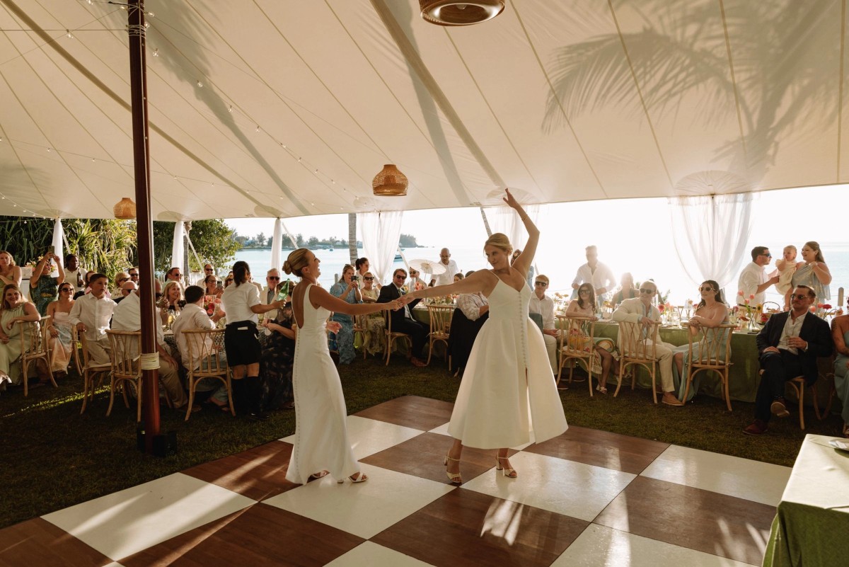 First dance on a checkerboard floor inside a sailcloth tent at a Bermuda wedding