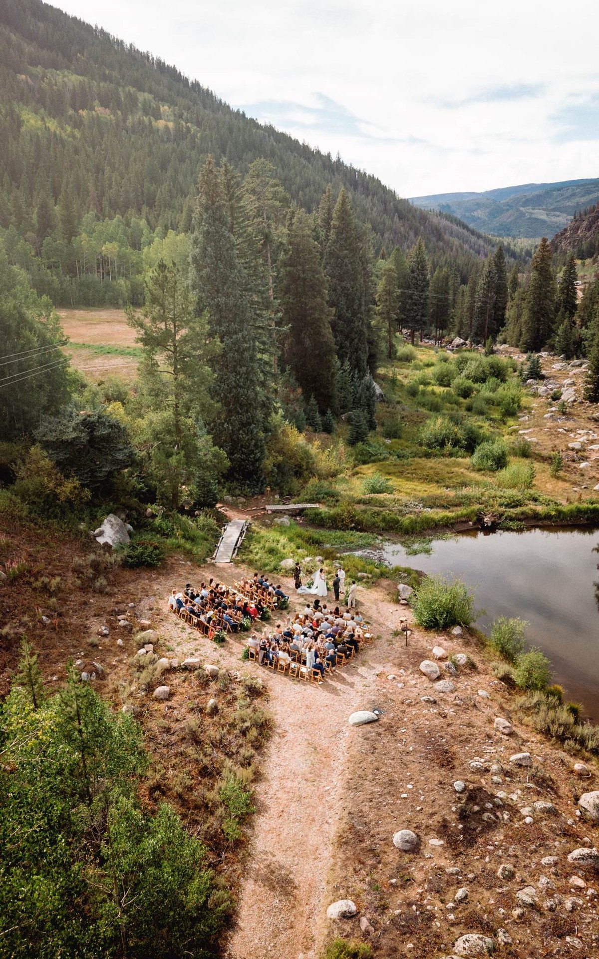 Aerial view of the ceremony circle beside the creek and pond at a mountain ranch among the aspens