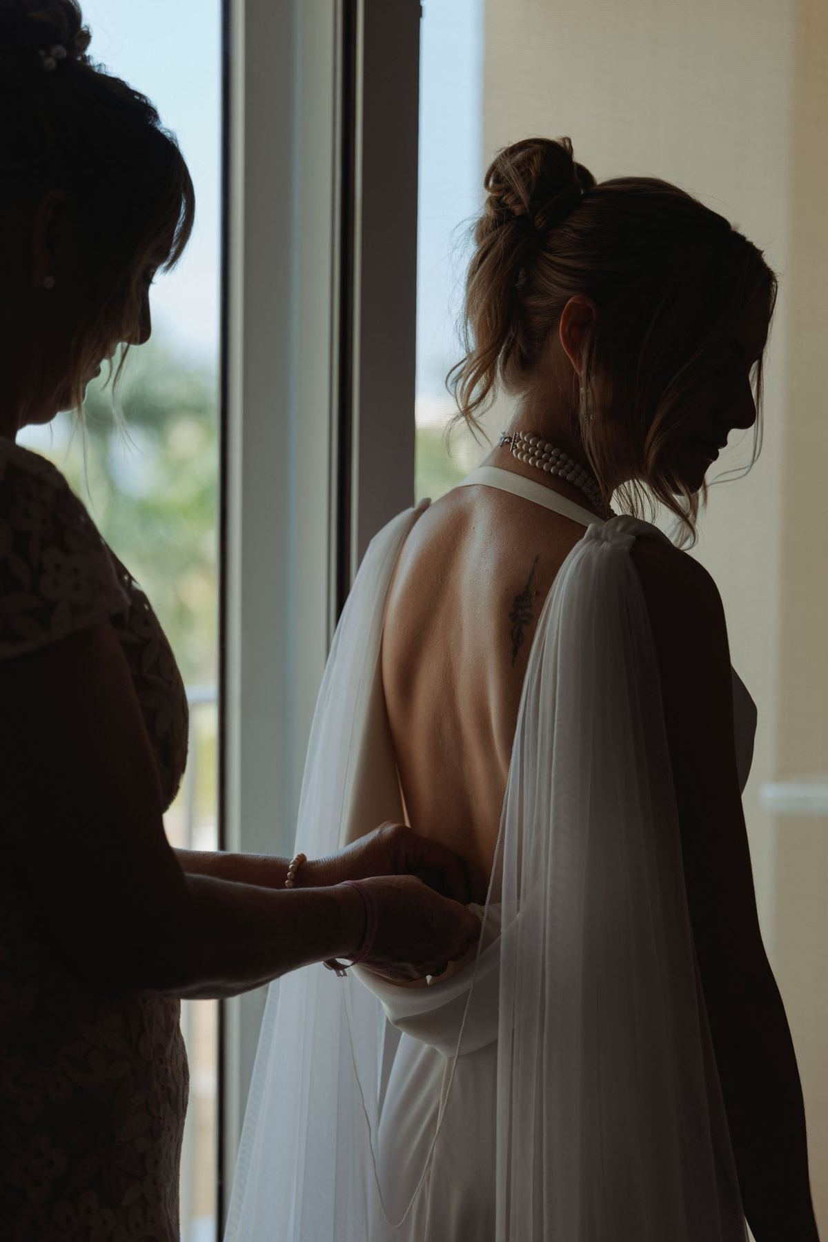 Candid bridal getting ready moment with natural window light