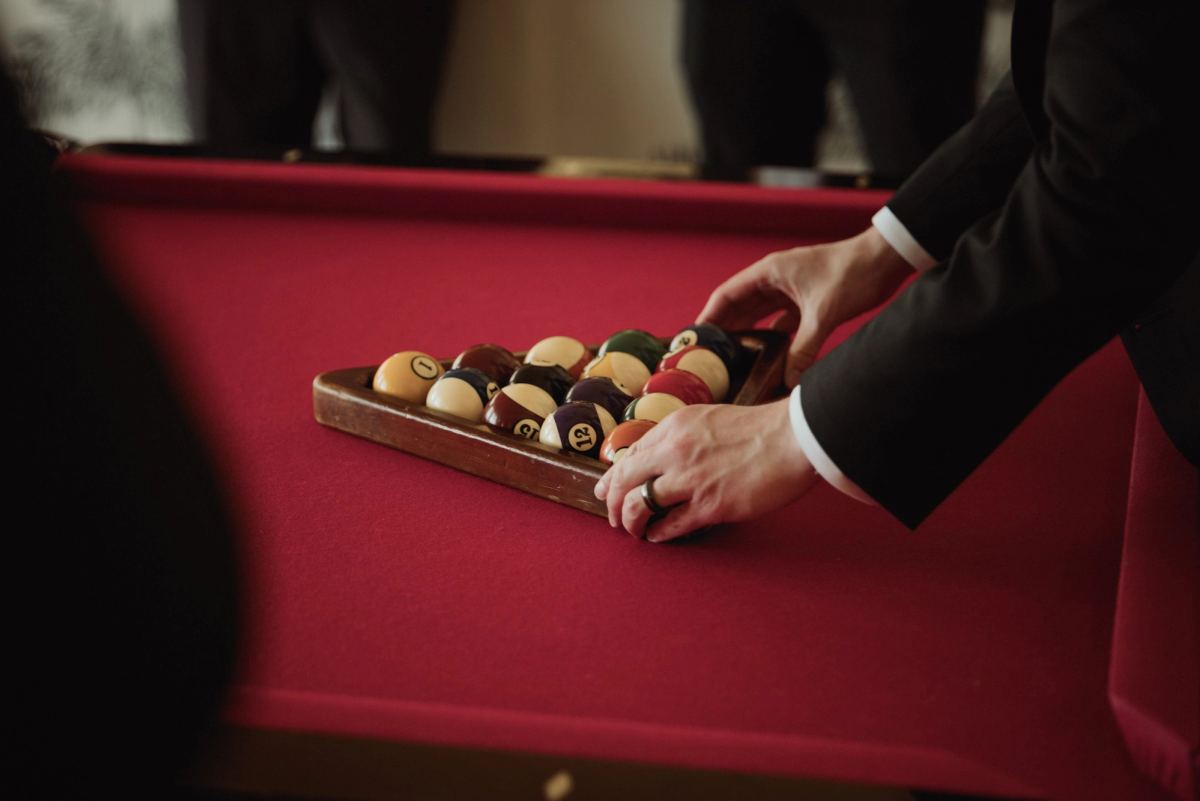 Detail of groom and groomsmen chocolates on red velvet tray at Bermuda wedding