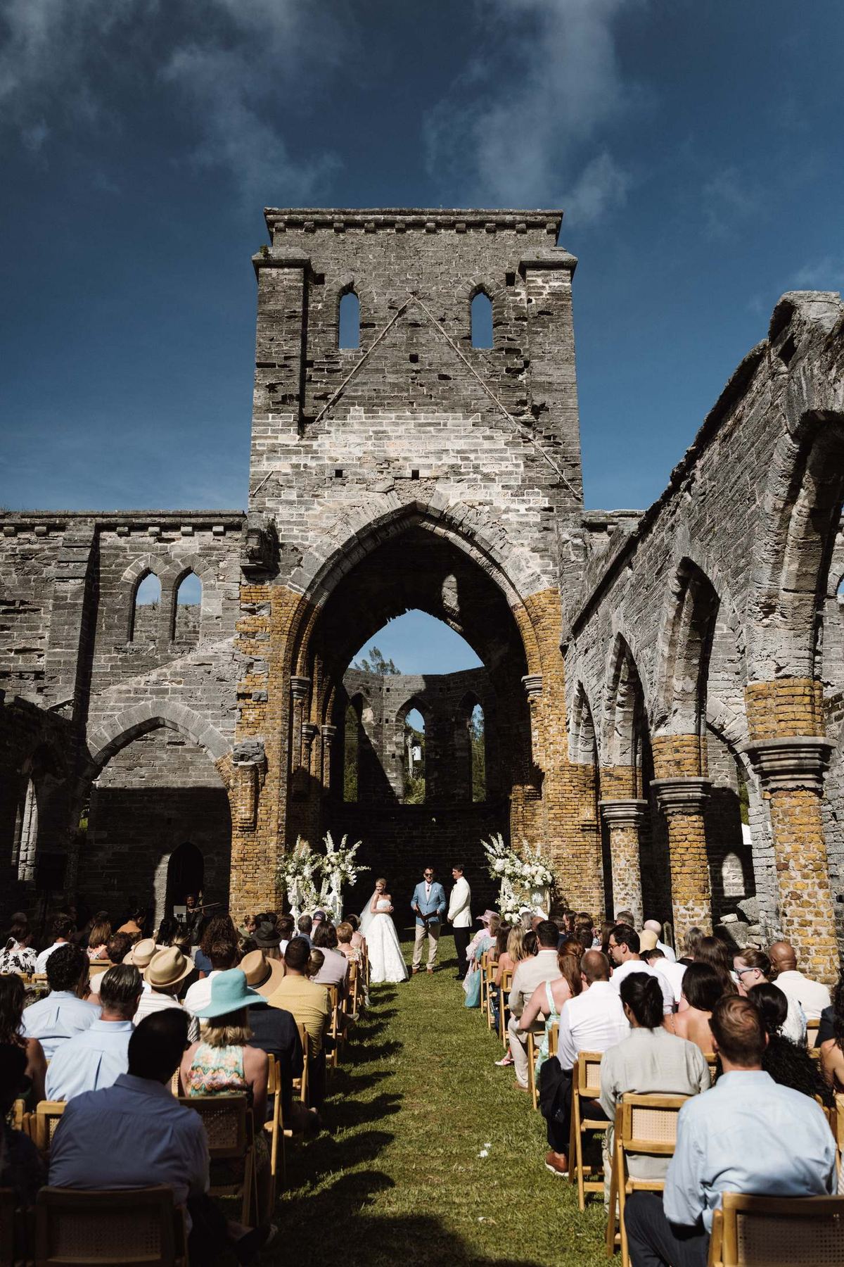 Ceremony seen from the back of the aisle inside the roofless Bermuda church ruins